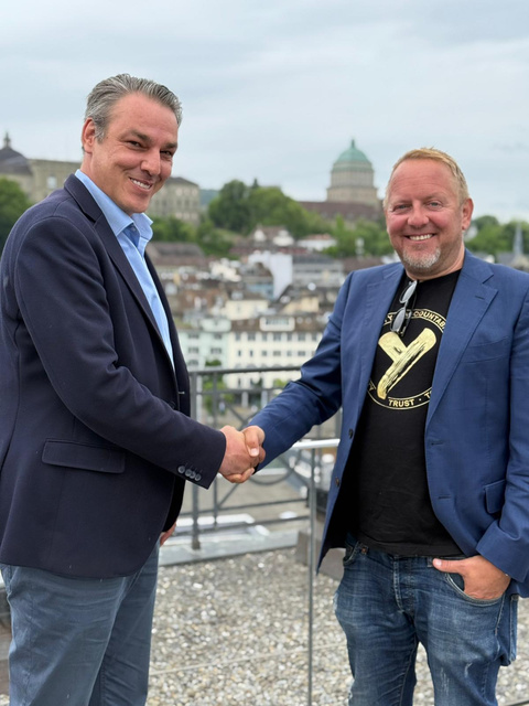 Gregor Zebic shaking hands with a partner on a Zurich rooftop