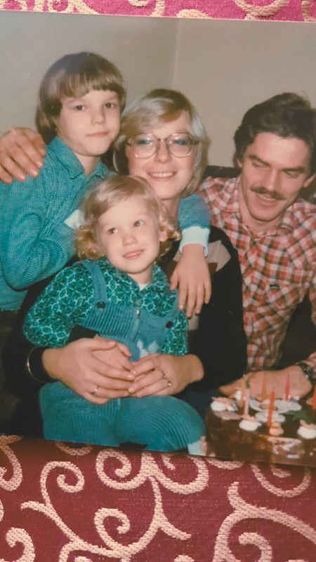 A family photograph from the 1970s with a young boy, a young girl, a woman and a man